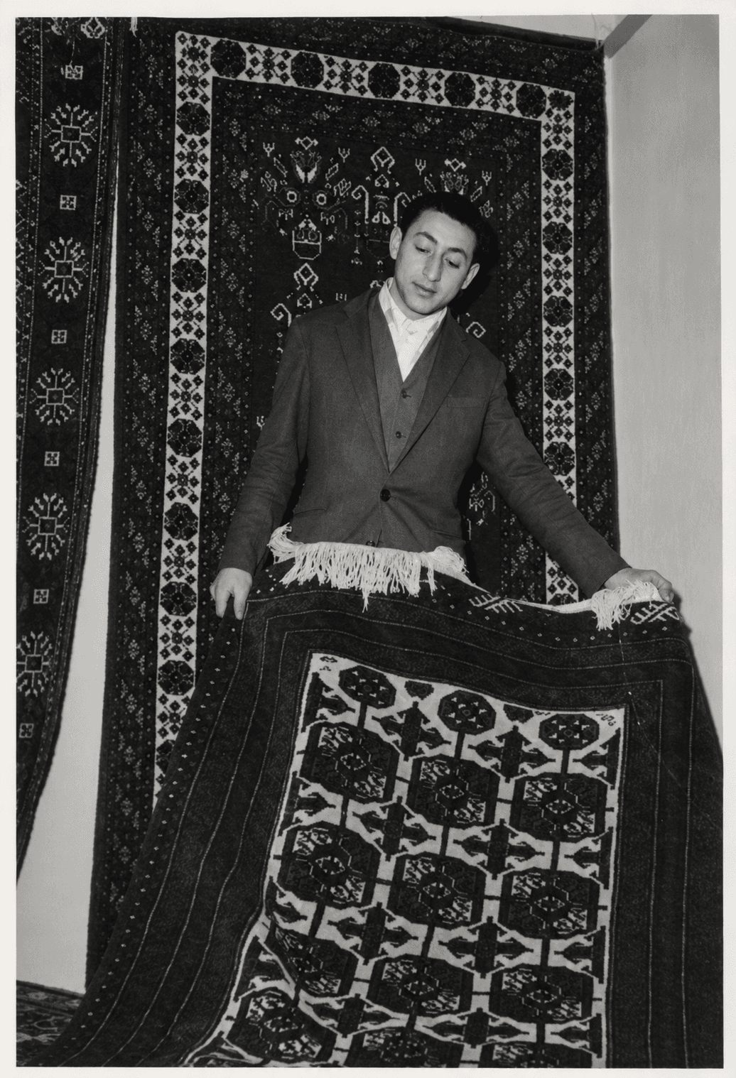 Father of Rugeast founder Alireza Bidabadi presenting a handmade rug