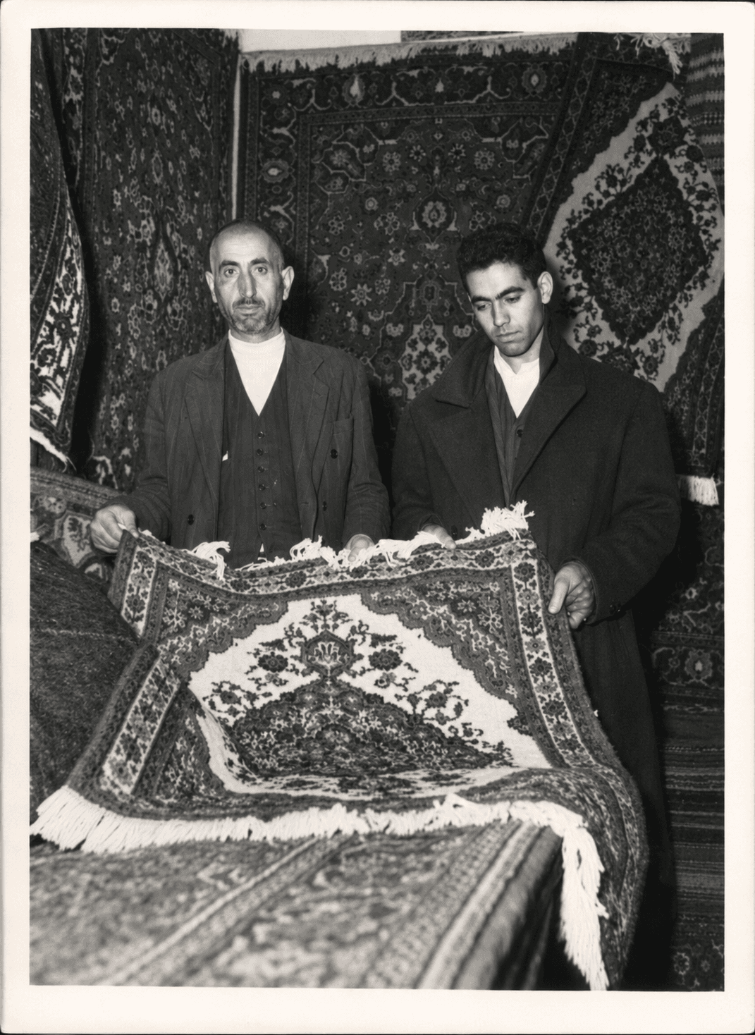 Grandfather and father of Rugeast founder Alireza Bidabadi with a handmade rug